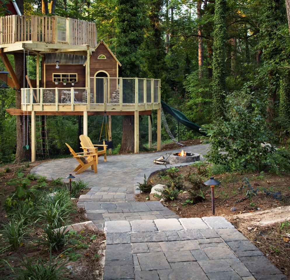 Treehouse with hardscape projects utilizing pavers and walls manufactured by Belgard Hardscapes.