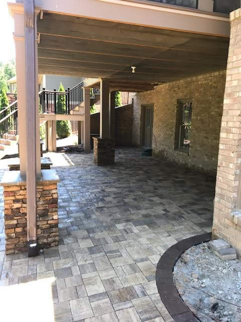 Paver Patio Under a Deck by Sugar Hill Outdoors