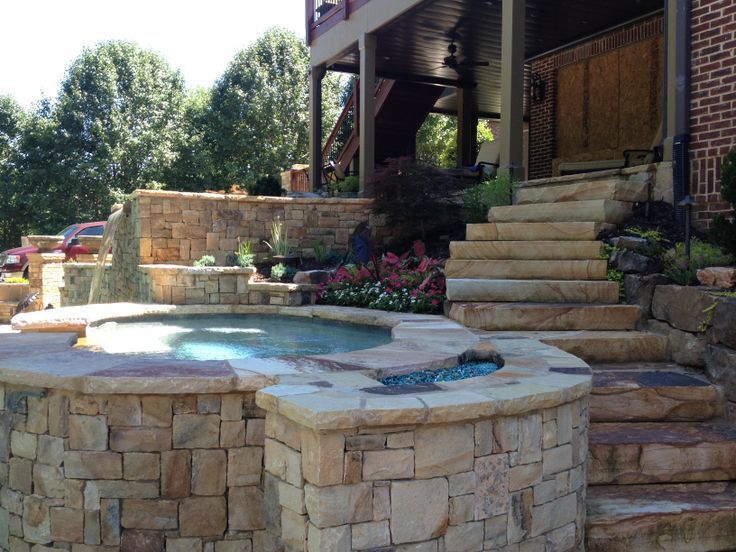 Hot Tub with Stone Work by Sugar Hill Outdoors