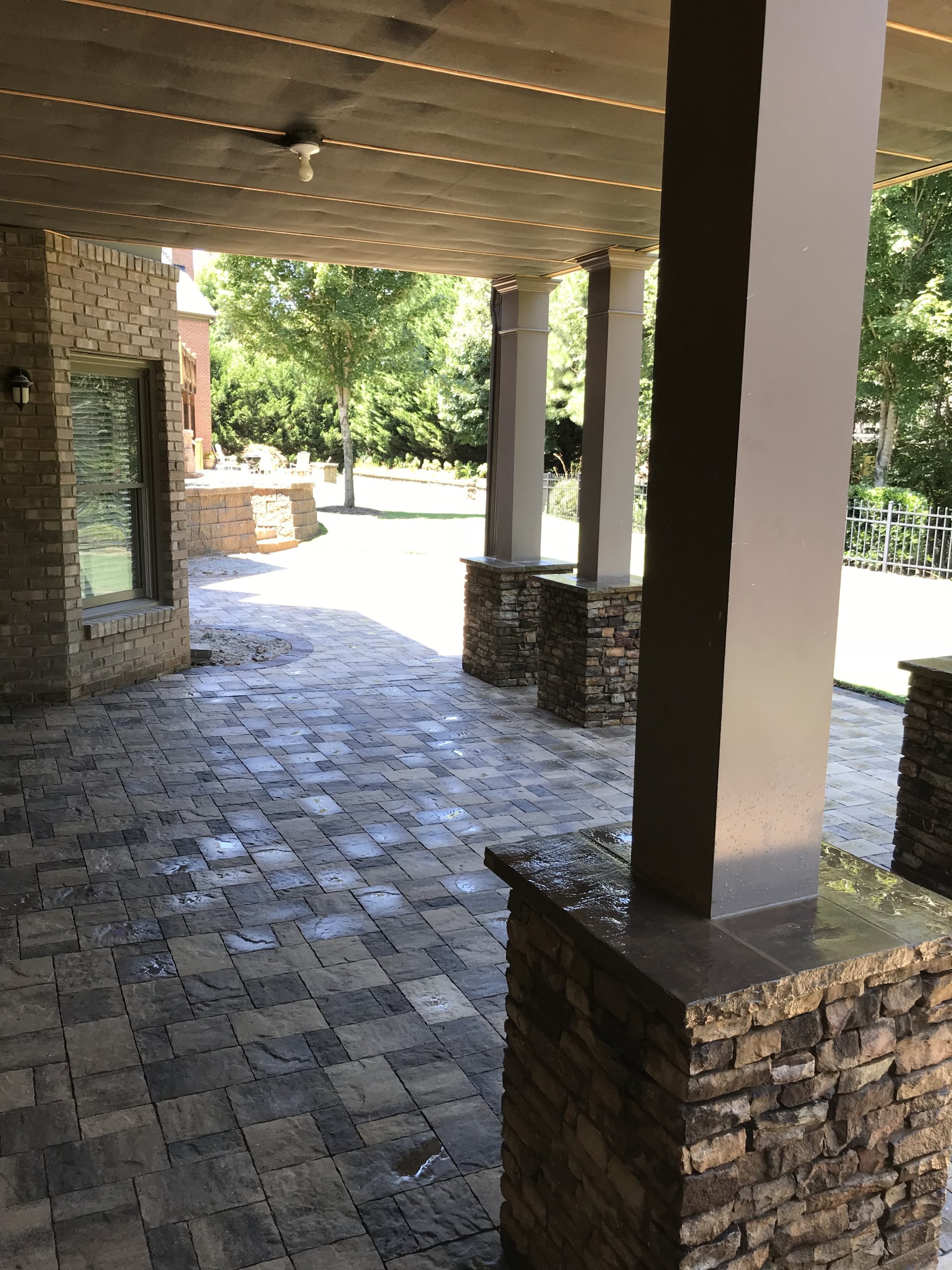 Patio Area under a Deck by Sugar Hill Outdoors