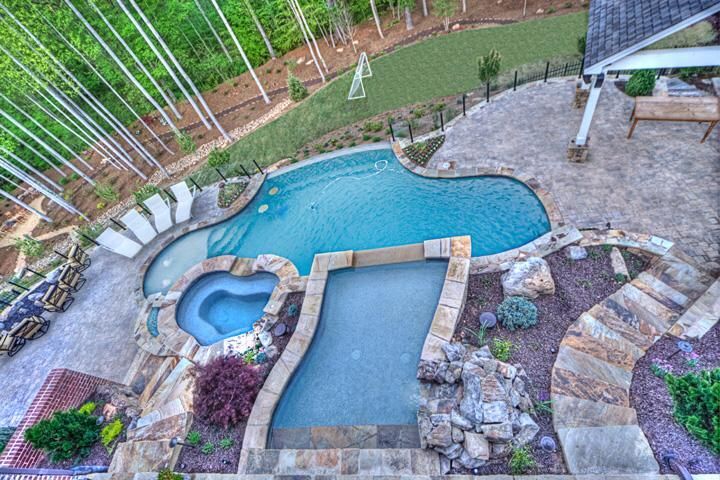 Pool with Stone Steps and Patio by Sugar Hill Outdoors