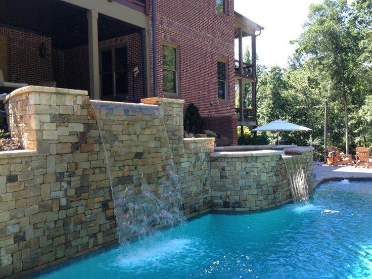 Pool with Stacked Stone Water Feature by Sugar Hill Outdoors