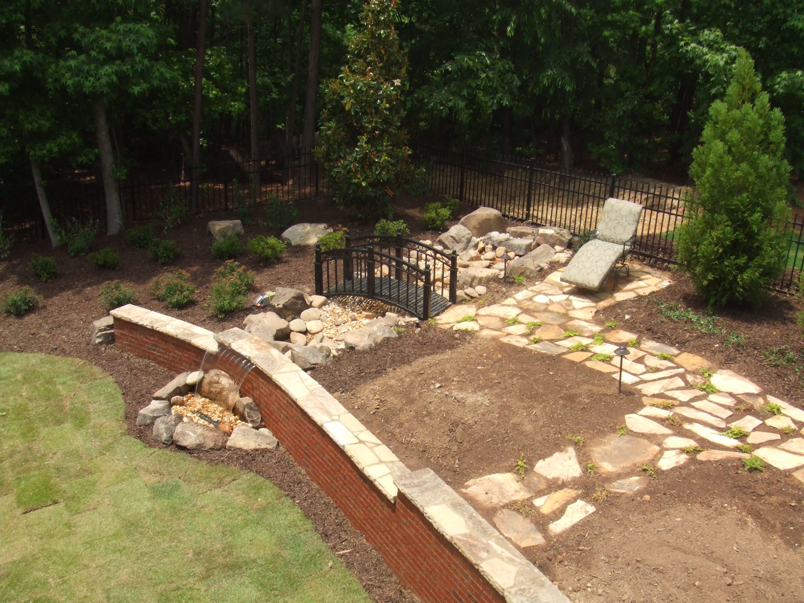 Landscaping with Walkways, a Bridge, and Water Feature by Sugar Hill Outdoors
